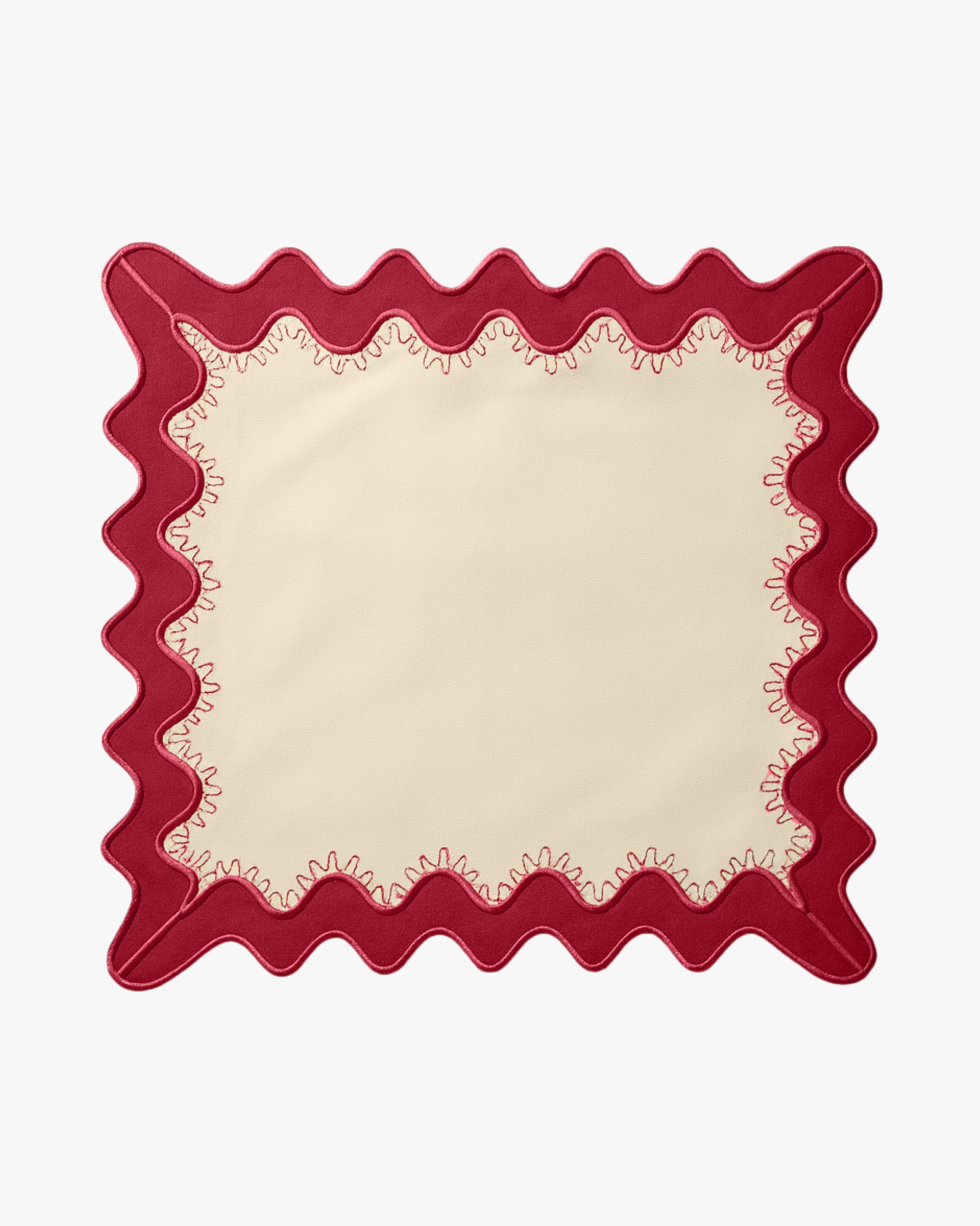 A cream napkin with a red boarder