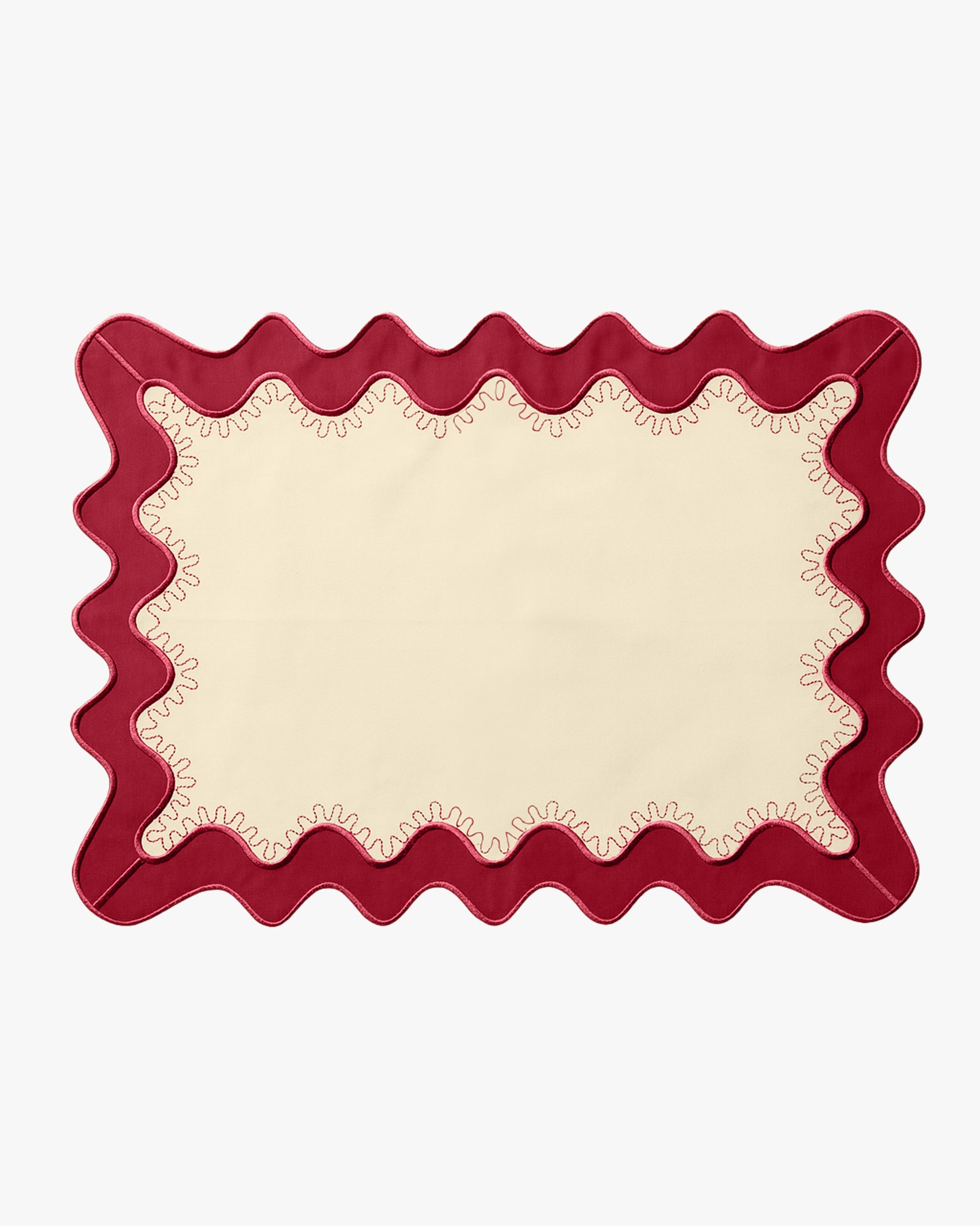 A cream placemat with a red boarder