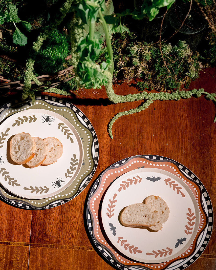 Two decorative plates with bread slices, styled on a wooden table.