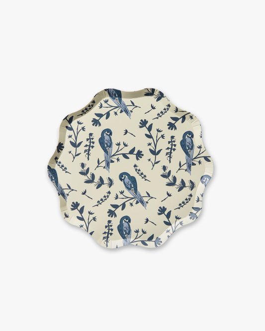 Round decorative plate with blue bird and leaf pattern on a white background