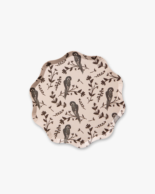 Decorative plate with bird and leaf pattern on a beige background