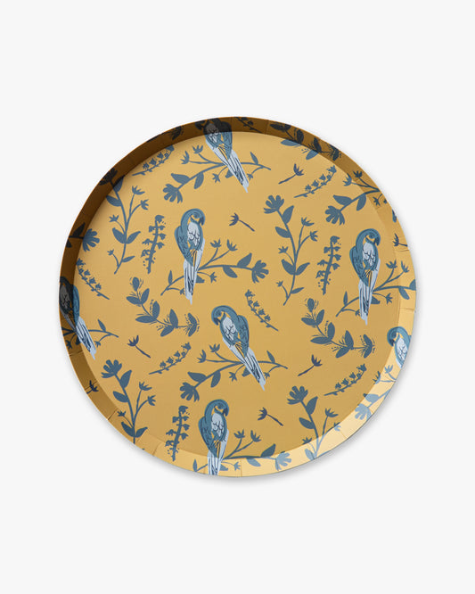 Round plate with blue bird and floral pattern on a yellow background