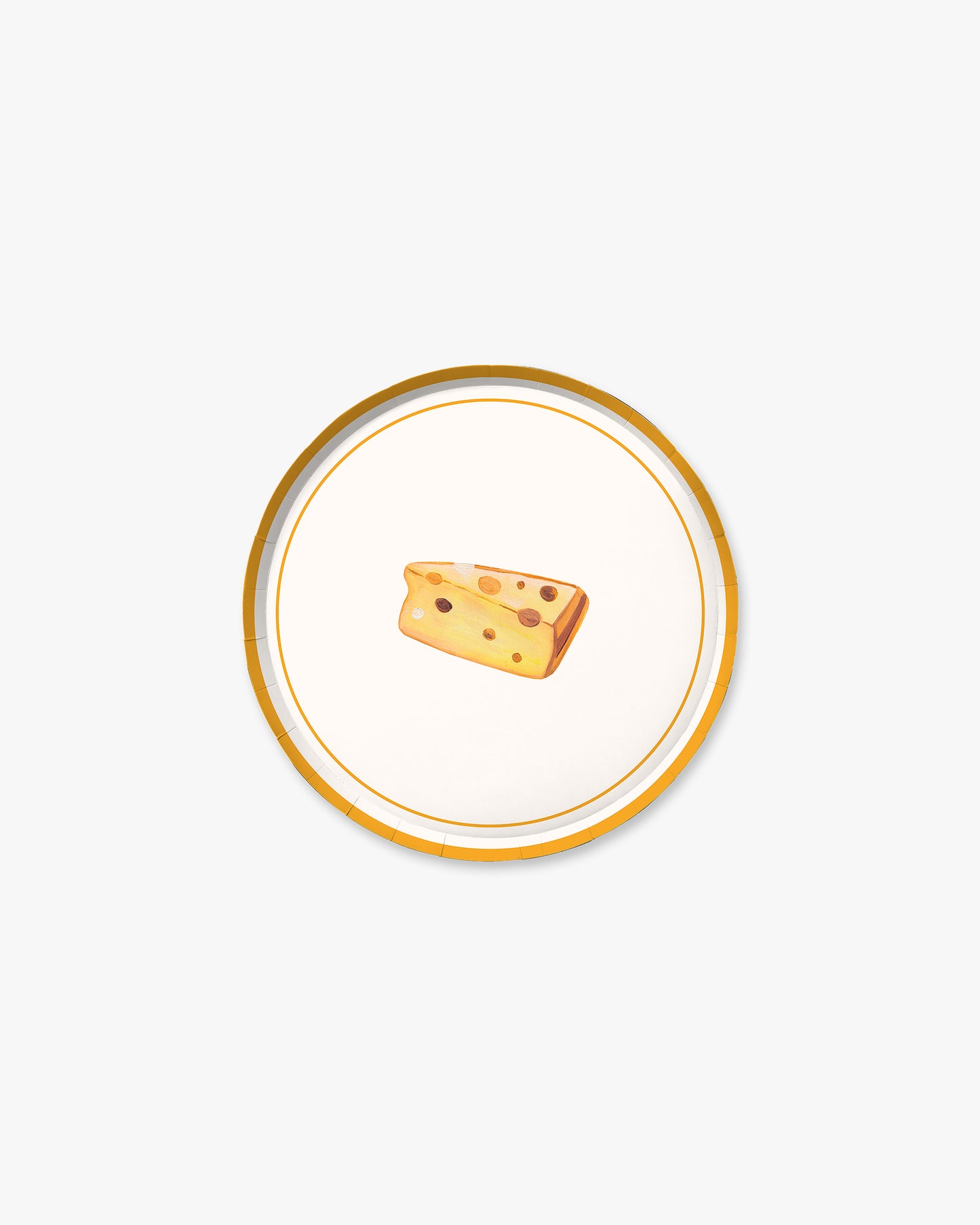 Small wedge of cheese on a decorative plate with a gold rim against a white background