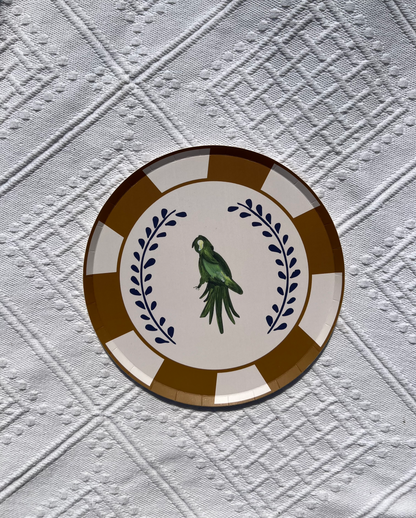 Decorative plate with a parrot design on a textured white background
