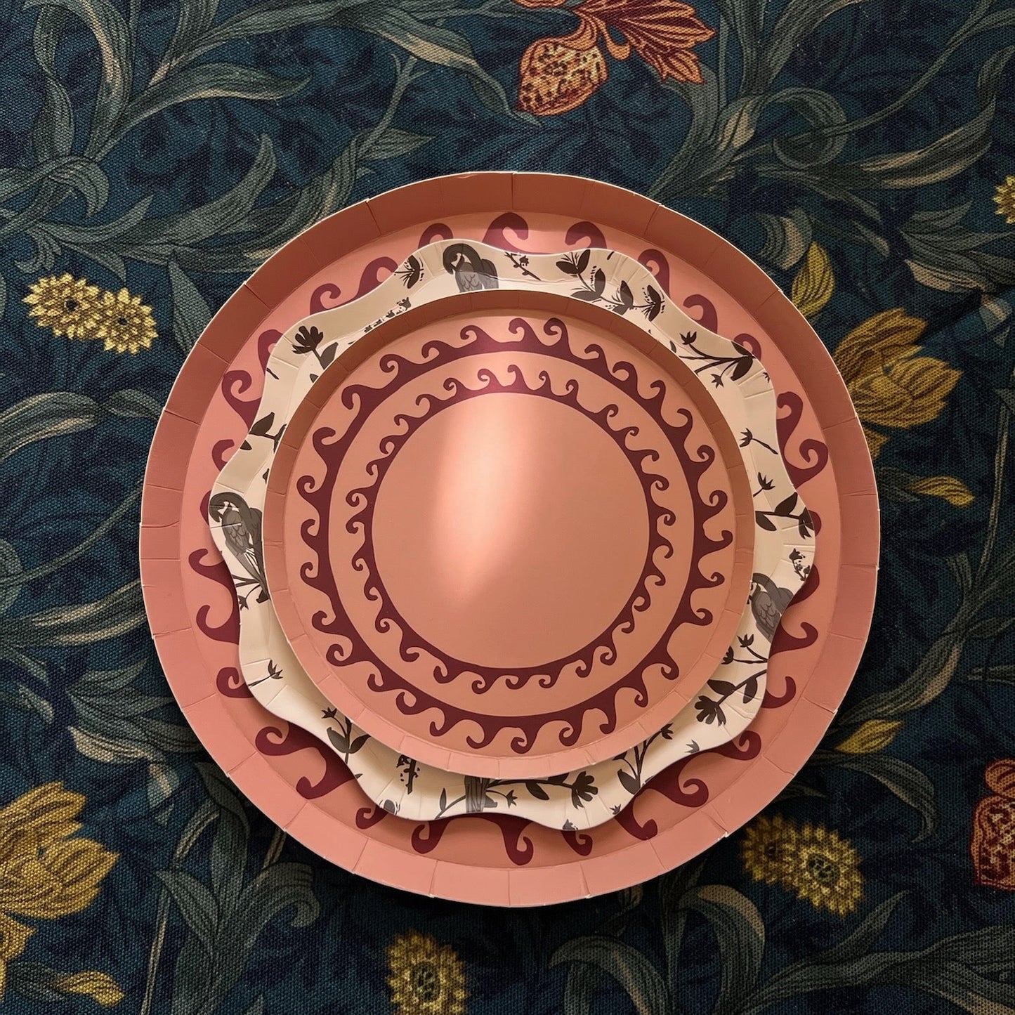 Decorative plates with intricate patterns on a floral background