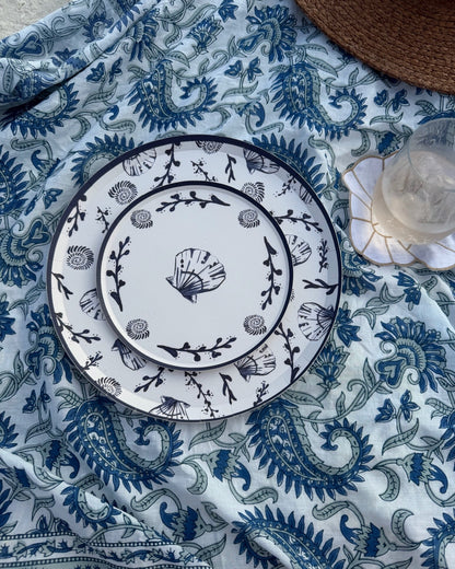 Decorative plates on a blue patterned blanket