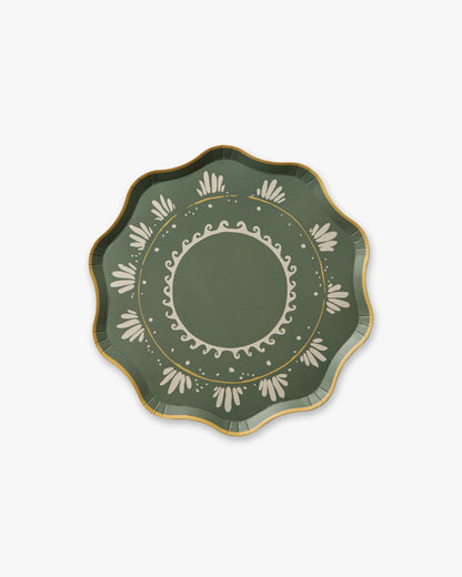 Decorative green plate with gold and white patterns on a white background