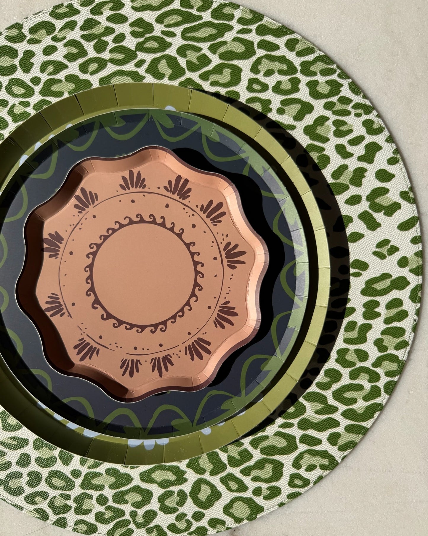 decorative plates stacked on a leopard placemat