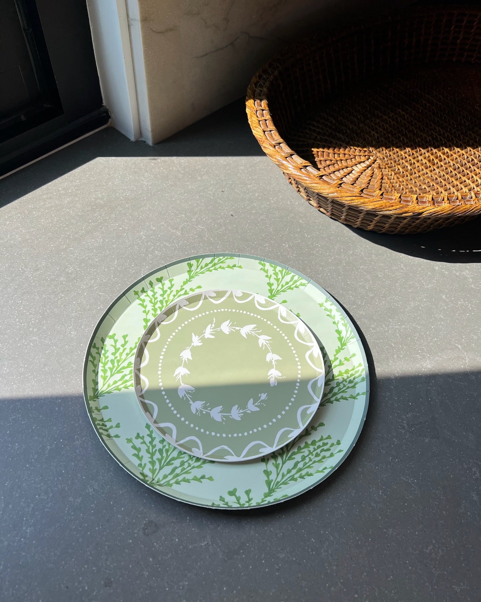 Decorative plates stacked on a countertop with sunlight hitting them