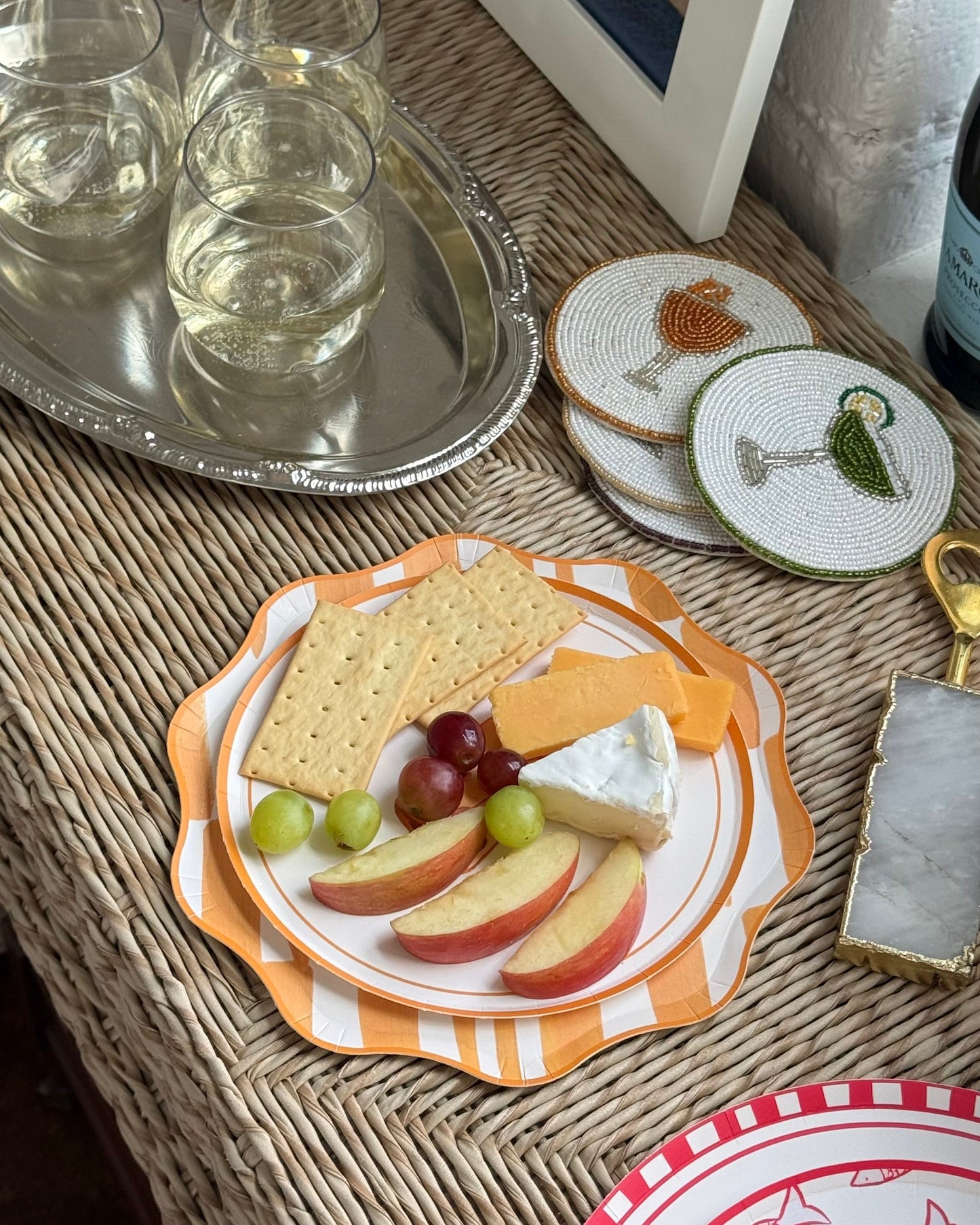 A decorative plate with cheese and crackers on it. 