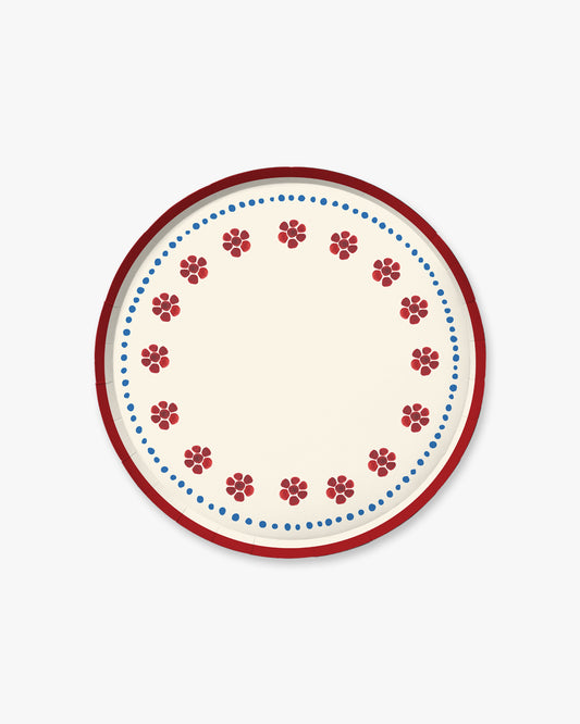 a red white and blue plate with floral details