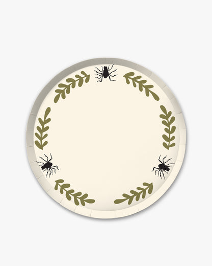 Cream colored paper plate with olive colored fern stem border and black spider detailing. 