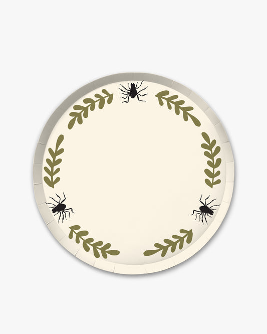 Cream colored paper plate with olive colored fern stem border and black spider detailing. 