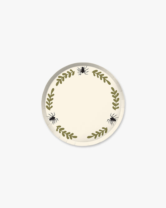 Cream colored paper plate with olive colored fern stem border and black spider detailing. 