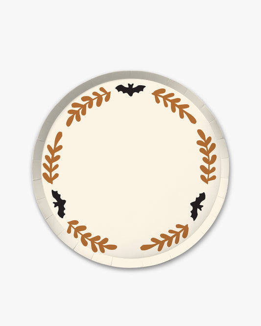 Cream colored paper plate with orange colored fern stem border and black bat detailing. 