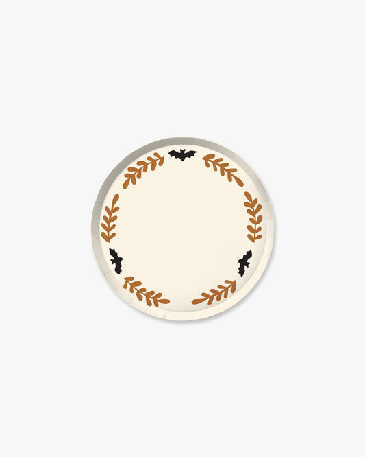 Cream colored paper plate with orange colored fern stem border and black bat detailing. 