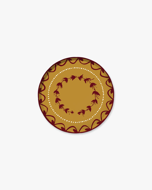 7-inch round decorative paper plate in a warm maple brown with burgundy floral and scalloped border details and a white dotted inner circle.