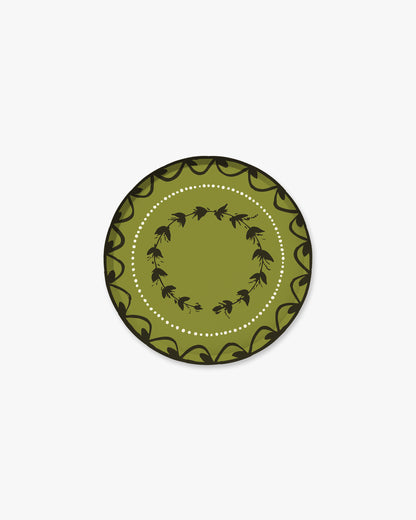 7-inch round decorative paper plate in olive green with a dark  floral border, inner floral wreath, and white dotted circle.