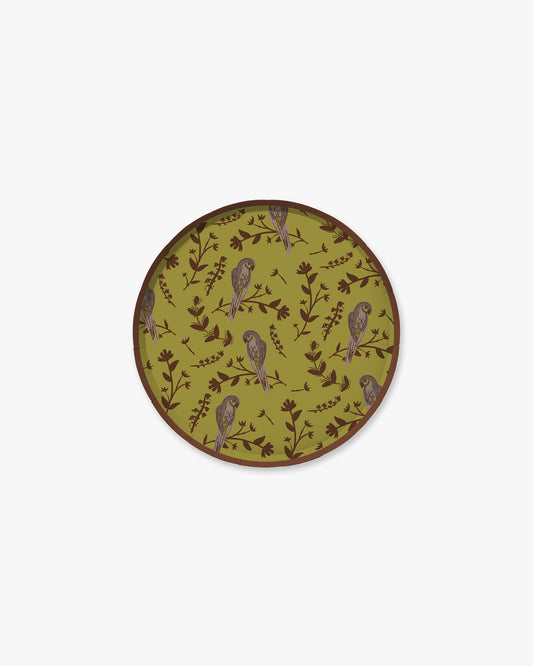 A green plate with a floral and bird pattern.