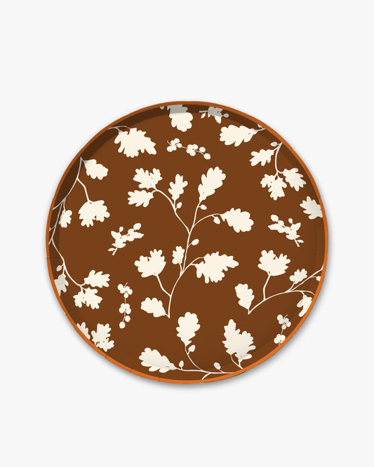Brown paper plate with white silhouette pattern of fall leaves. 
