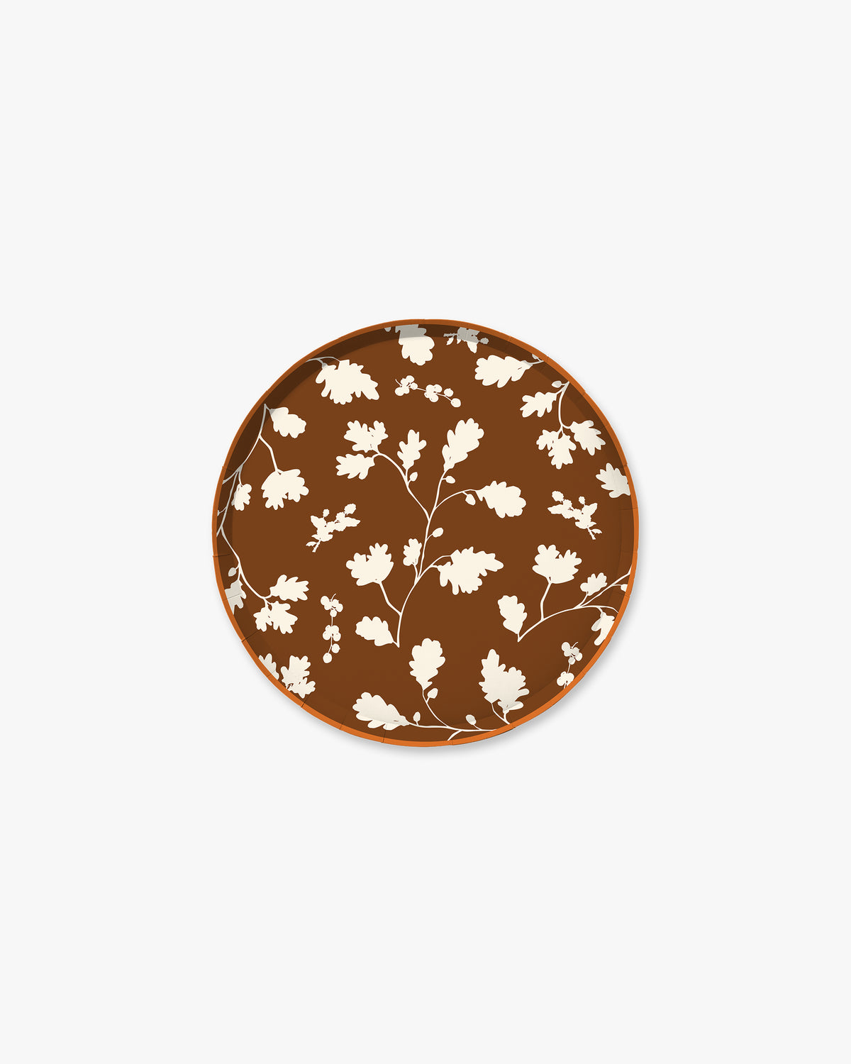 Dark brown paper plate with white silhouette pattern of fall leaves. 