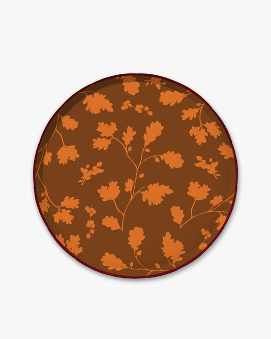 Brown paper plate with orange silhouette pattern of fall leaves. 