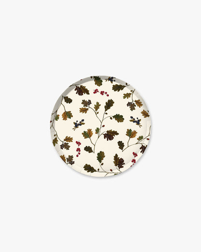 A round decorative plate featuring a vintage botanical pattern of oak leaves and small berries on an off-white background, shown against a plain light gray backdrop.