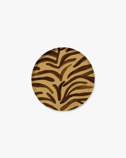 A round paper plate featuring a brown and tan zebra-like organic stripe pattern, centered on a light gray background.