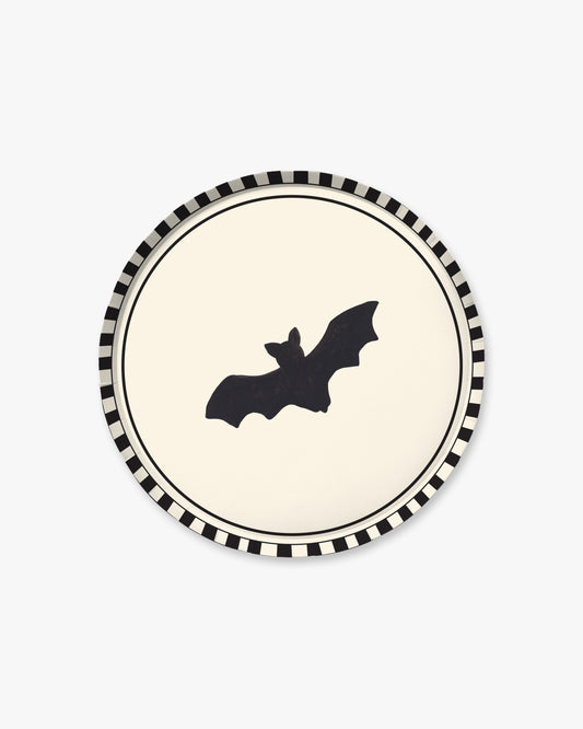 9-inch round decorative paper plate with a cream center, black bat silhouette, black double-line border, and black-and-white striped rim.