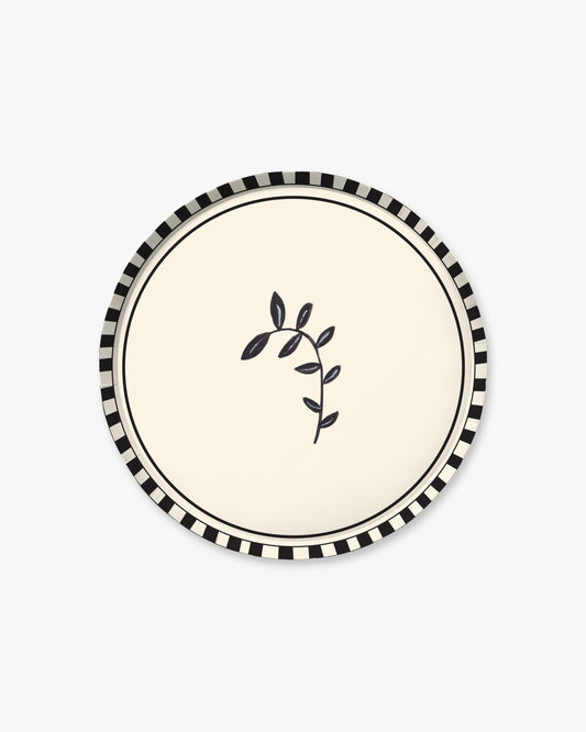 9-inch round decorative paper plate with a cream center, black branch silhouette, black double-line border, and black-and-white striped rim.
