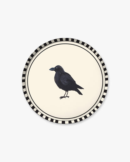 9-inch round decorative paper plate with a cream center, black crow silhouette, black double-line border, and black-and-white striped rim.