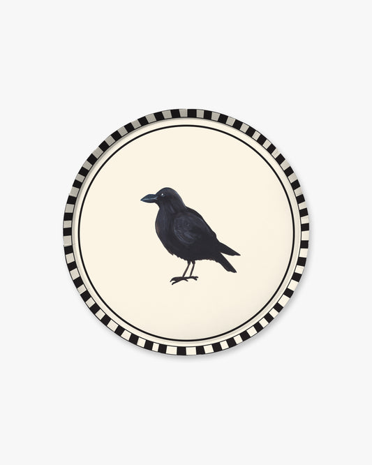 9-inch round decorative paper plate with a cream center, black crow silhouette, black double-line border, and black-and-white striped rim.