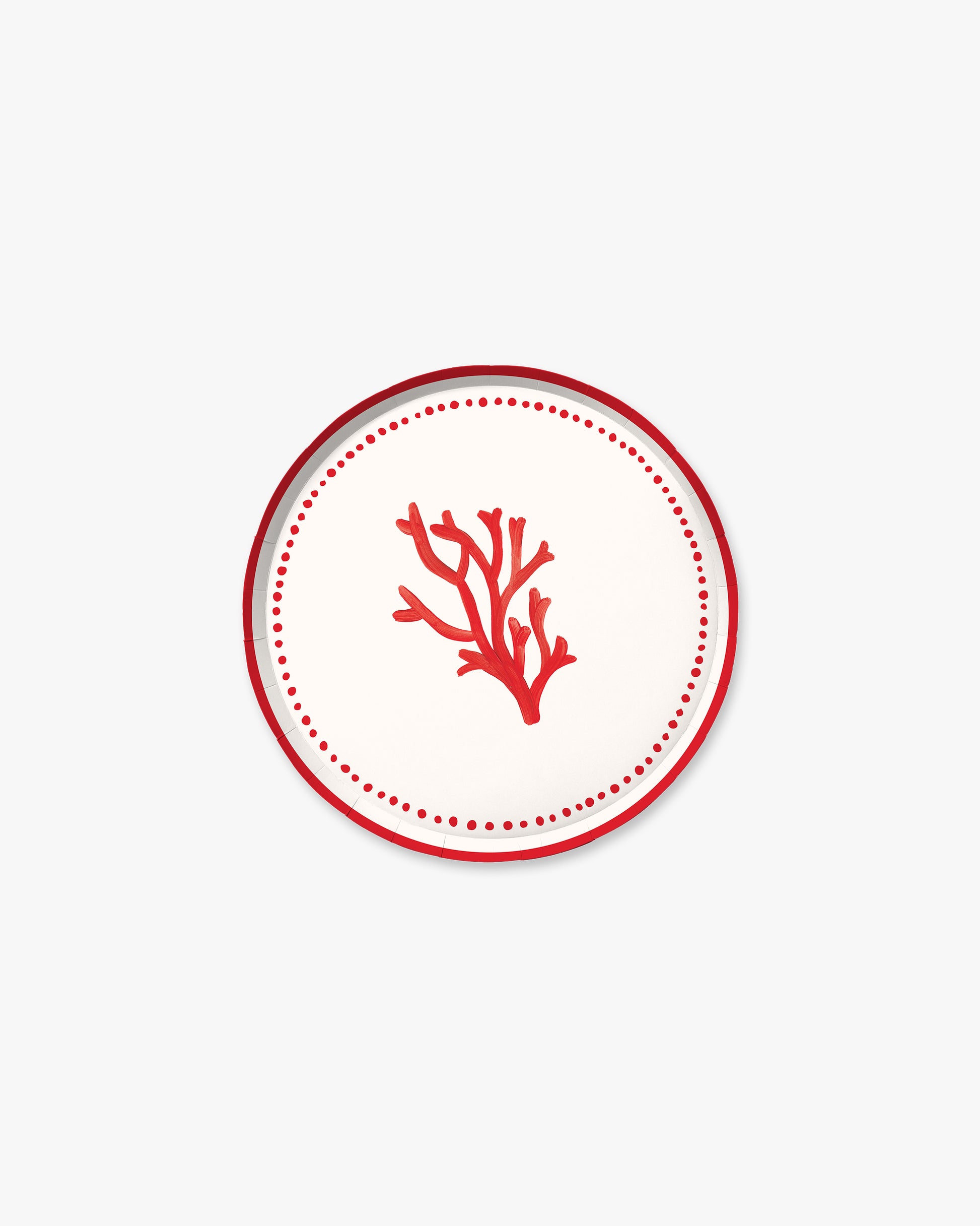 A white plate with a red piece of coral in the center