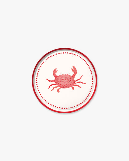 A white plate with a red crab in the center