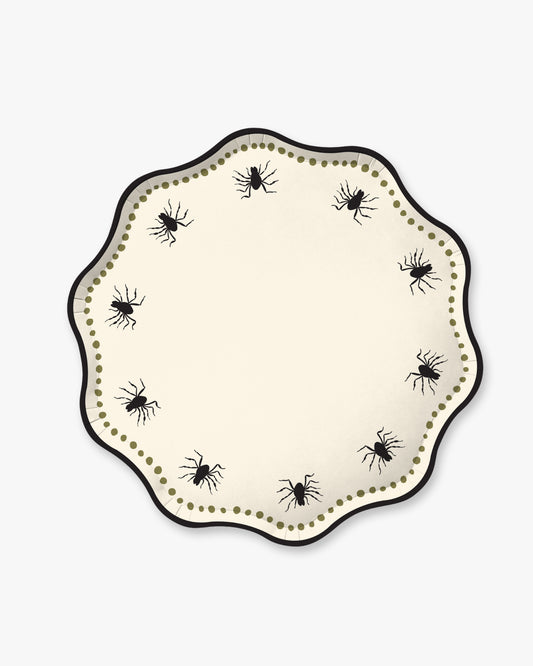 Cream colored paper plate with scalloped edges featuring a dotted olive border and black spider detailing.