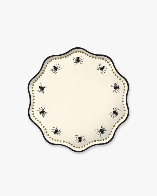 Cream colored paper plate with scalloped edges featuring a dotted olive border and black spider detailing.