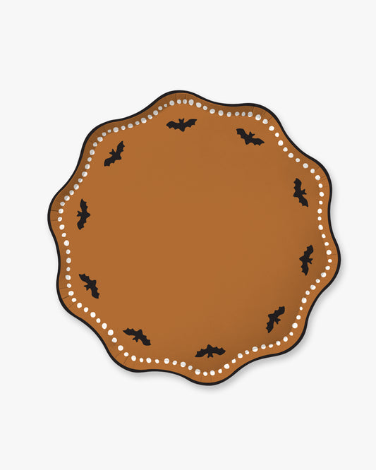 Orange colored paper plate with scalloped edges featuring a dotted white border and black bat detailing.