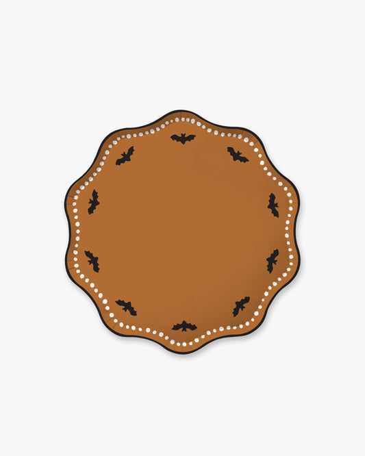 Orange colored paper plate with scalloped edges featuring a dotted white border and black bat detailing.