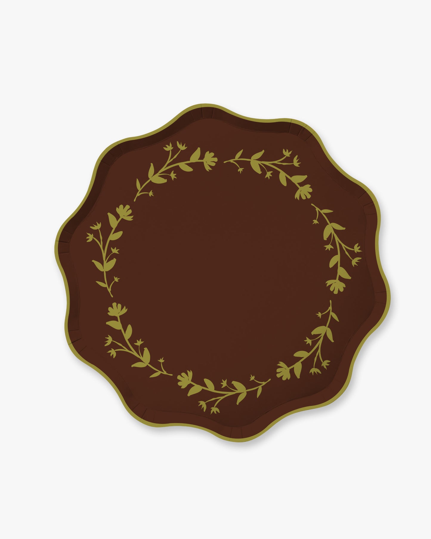 A scalloped plate with a brown background and a green floral ring around the edge. 
