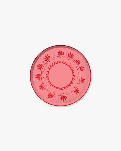 a pink and red decorative plate on a white background