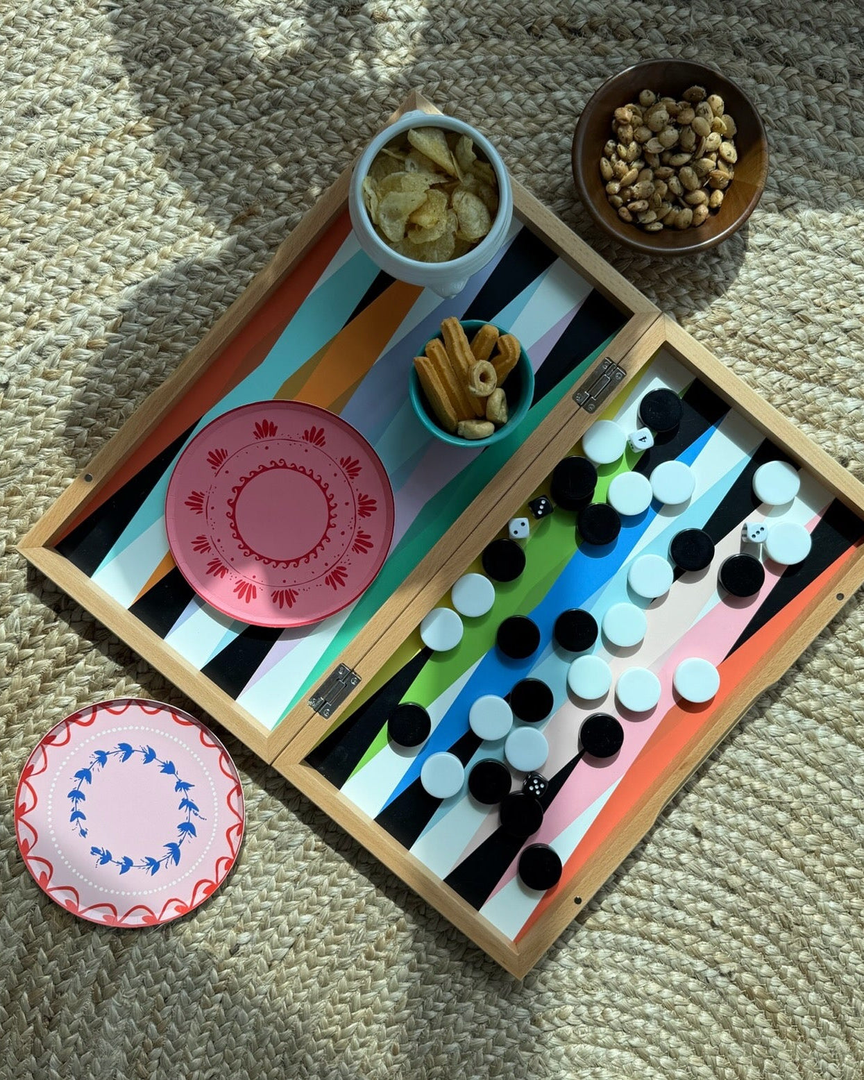 Two plates and some snacks on a game board