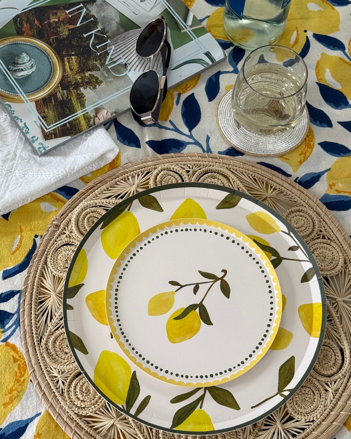 Decorative plates with lemons on them on a table cloth with lemons