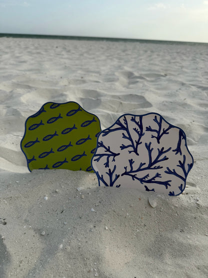 Two decorative plates in the sand