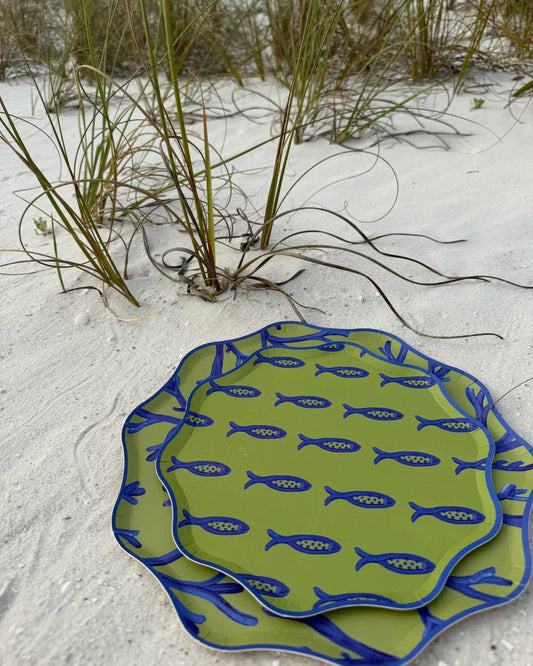 Blue and green decorative plates in the sand
