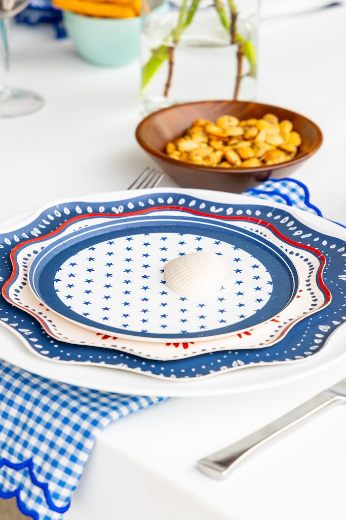 Decorative plate with blue and white pattern on a checkered tablecloth