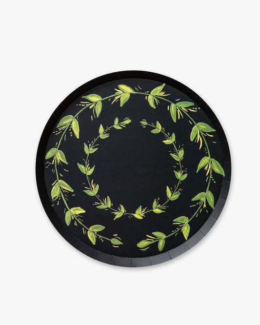 Round navy plate with green leaf designs 