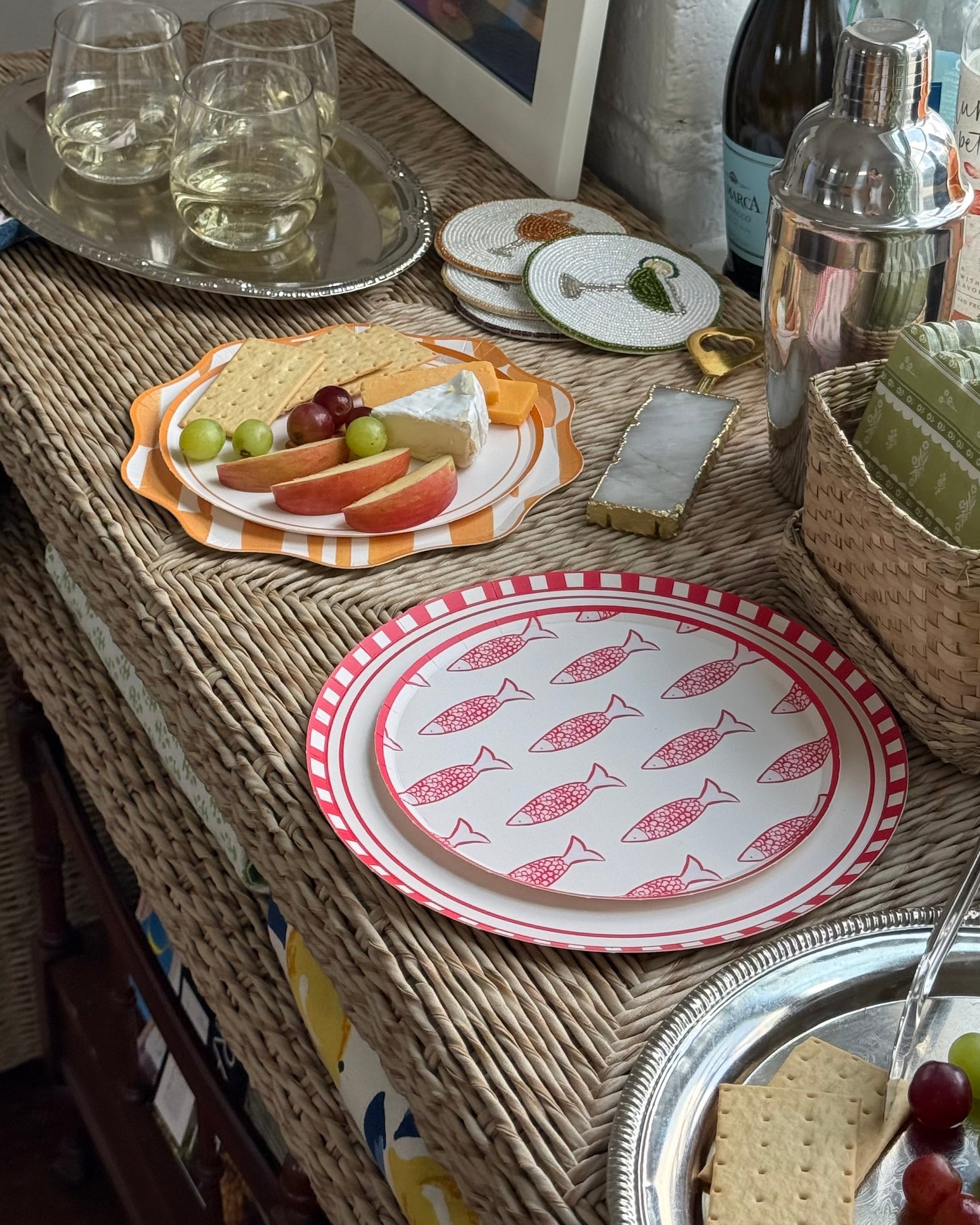 decorative plates with apples, and cheese on a cocktail table