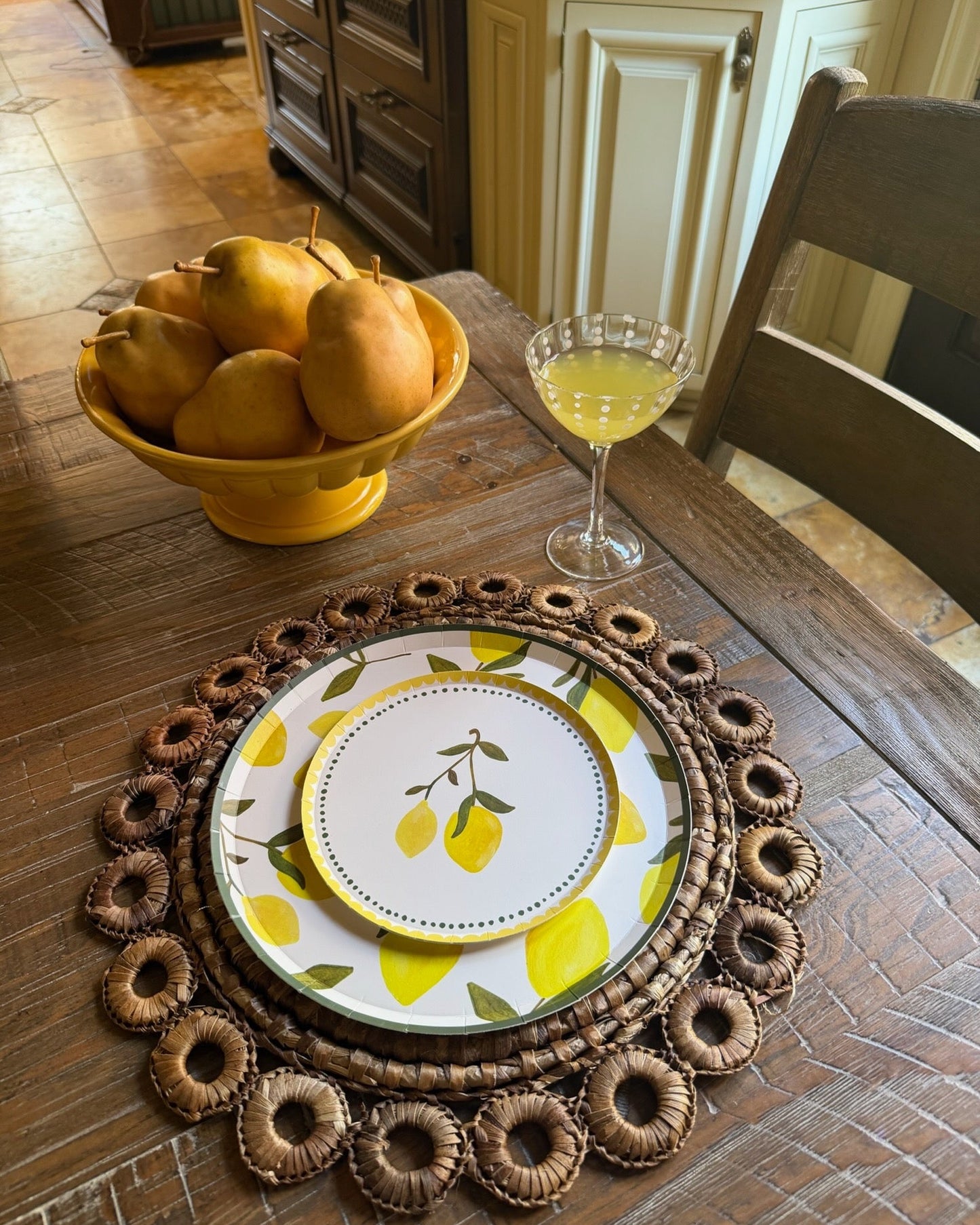 plates with lemons on them on a wood table